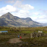 A photo of a two people in front of a mountain